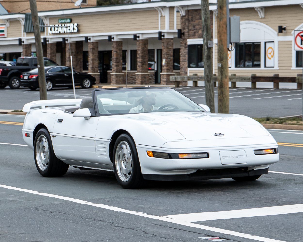 White convertible sports car with pop-up headlights and aerodynamic design