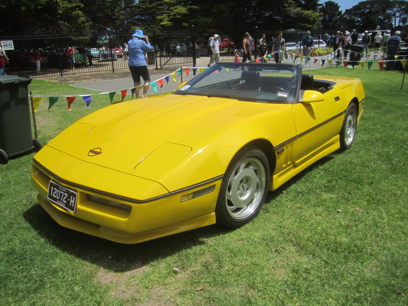 Yellow convertible sports car with pop-up headlights and sleek aerodynamic design