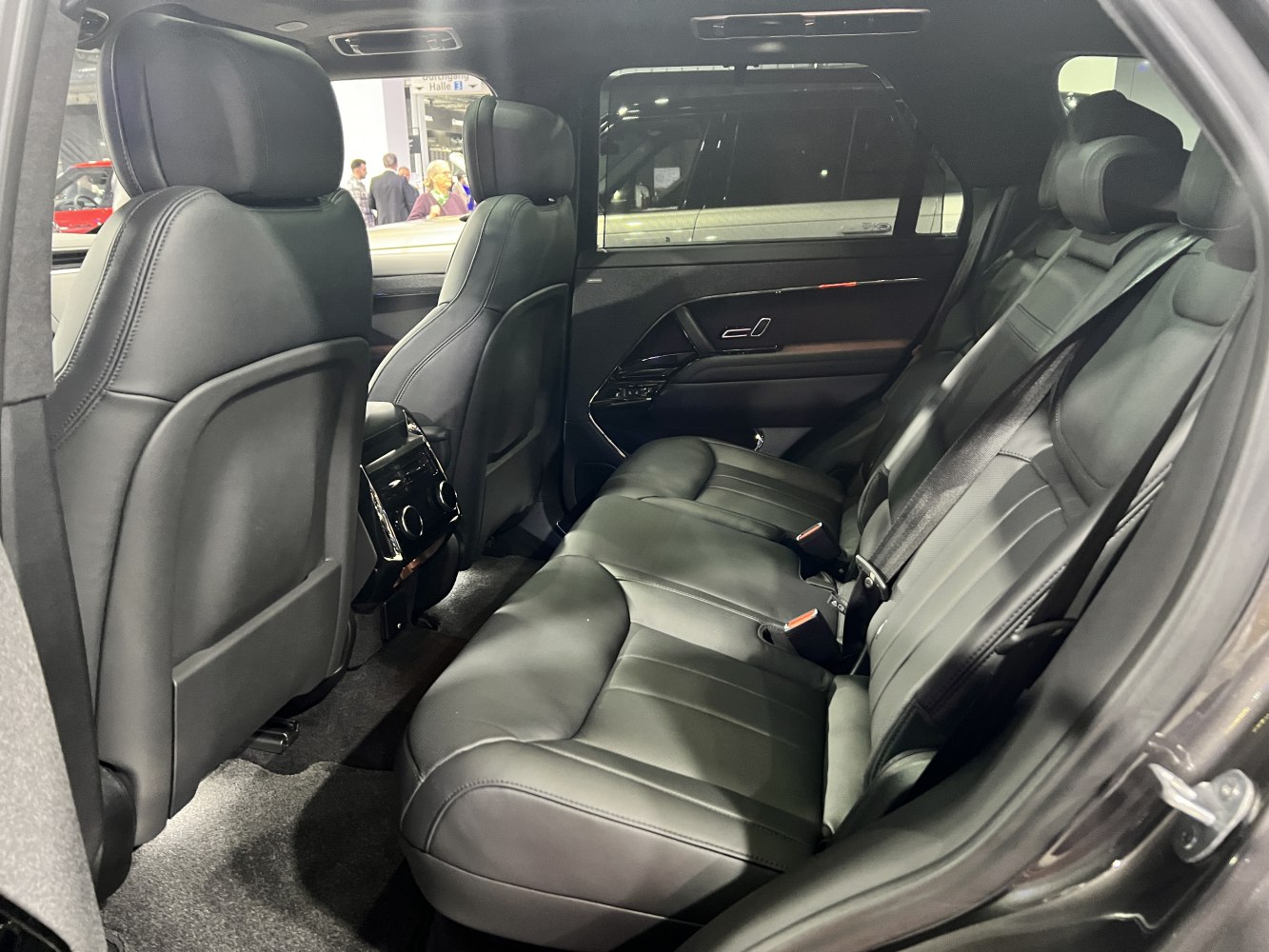 Black leather rear passenger seating with spacious cabin and modern car door design