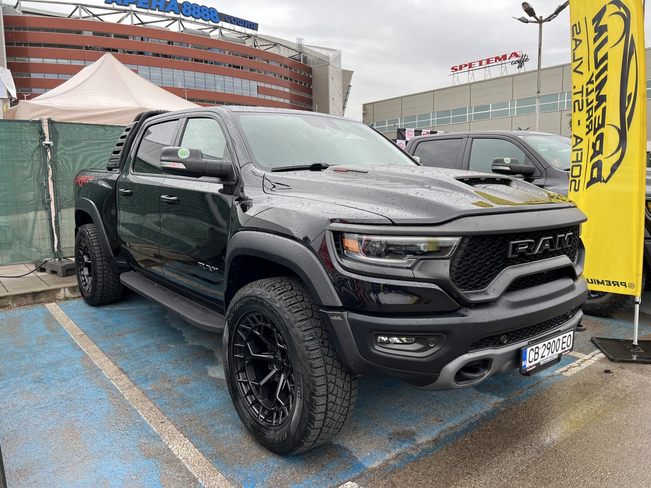 Black pickup truck front side view with aggressive grille and robust offroad tires