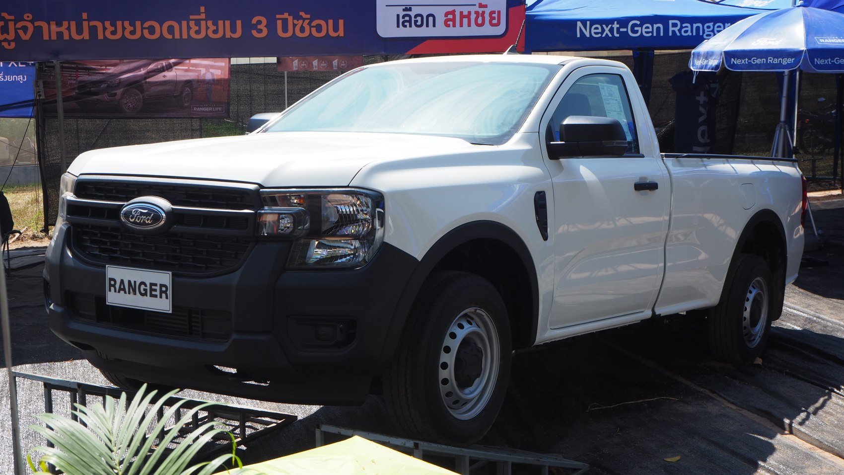 Front and side view of pickup truck with black grille and steel wheels