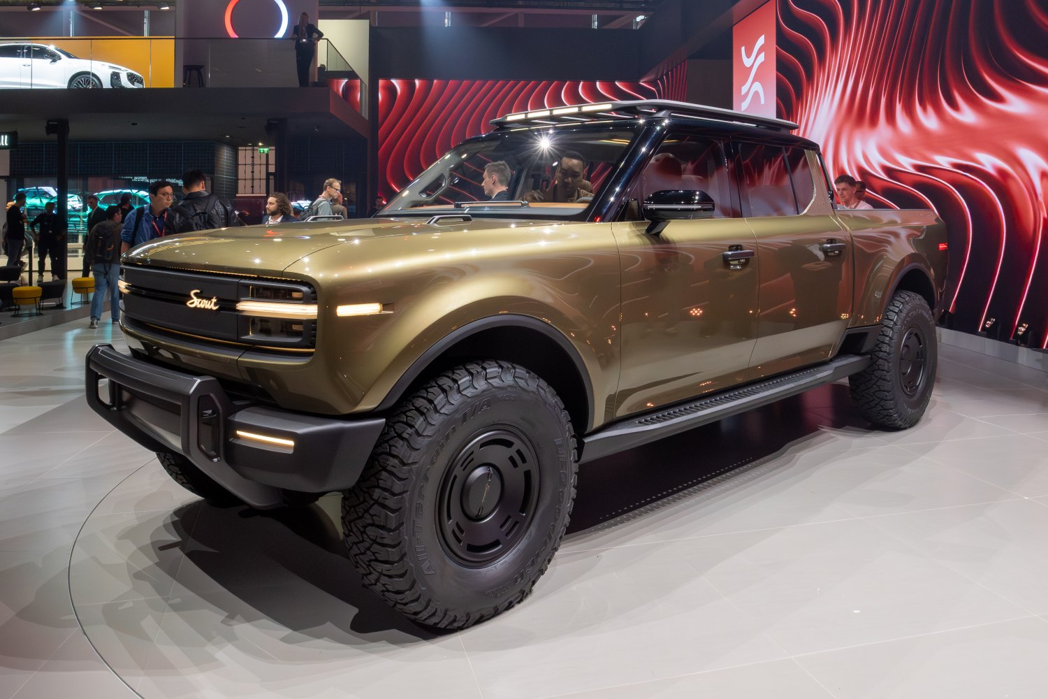 Electric pickup truck front side with distinctive grille and rugged tires