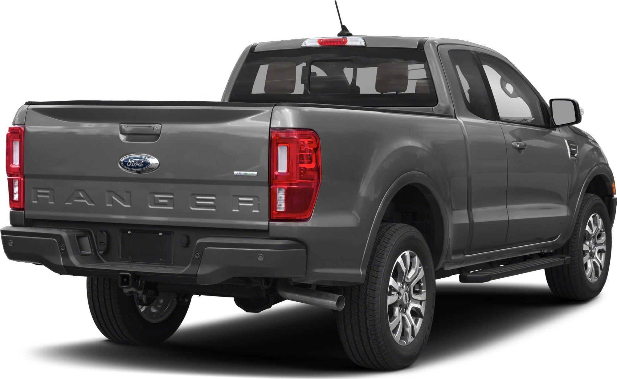 Rear view of pickup with extended cab, embossed tailgate, and alloy wheels.