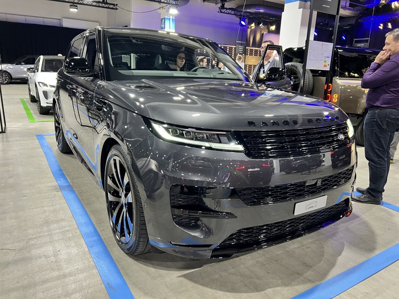 Front view of a luxury SUV with sleek LED headlights and modern grille design