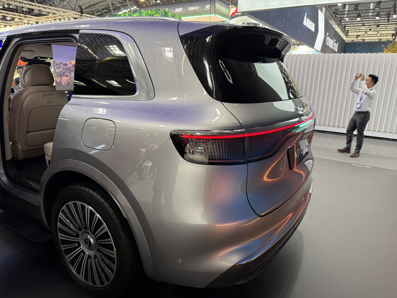 Rear view with sleek tail light and open rear door