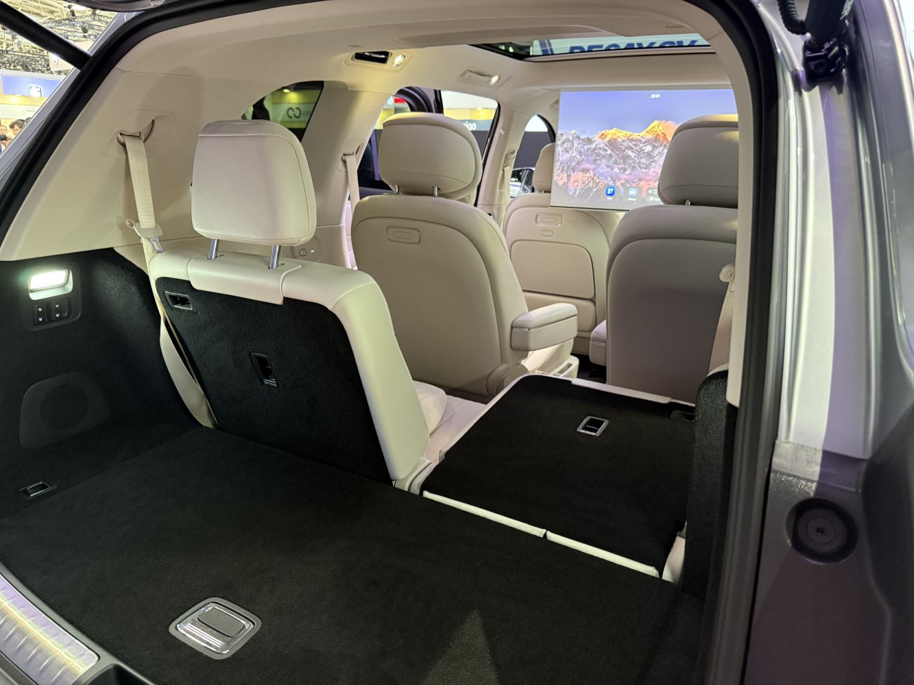Spacious cargo area with foldable rear seats and beige leather interior