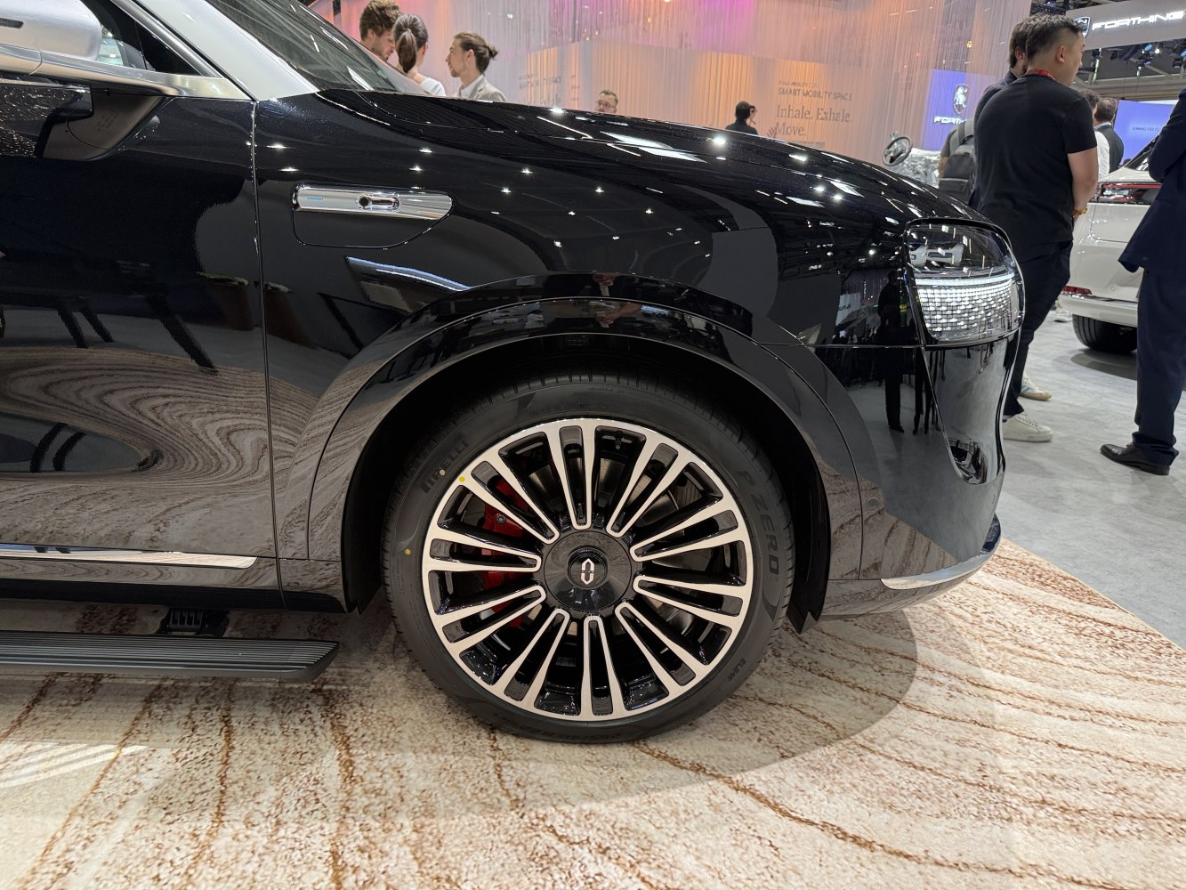 Front wheel and fender with alloy rim of a black modern vehicle