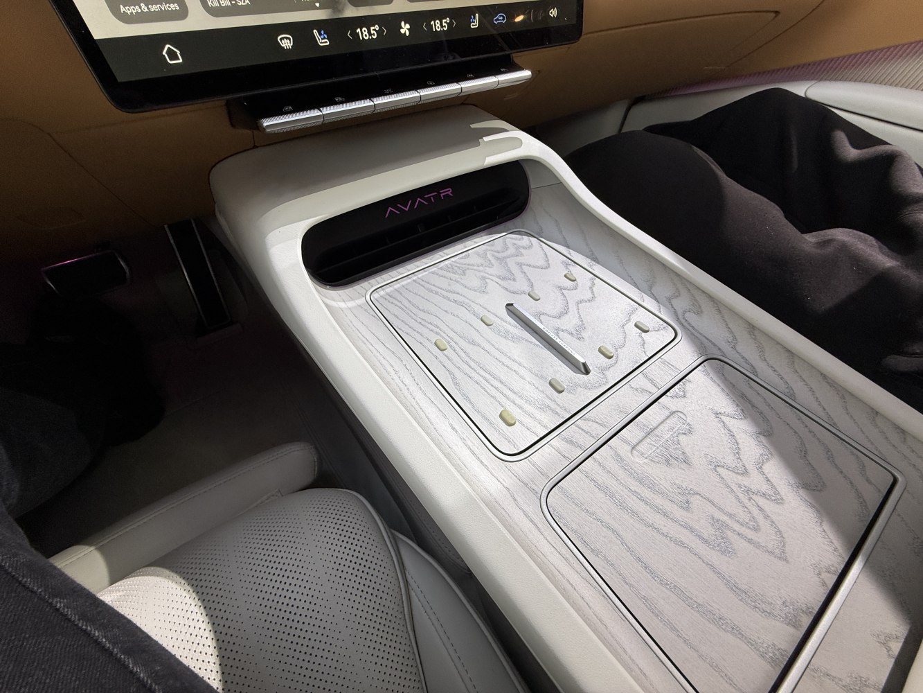 Center console with wood grain finish and integrated controls