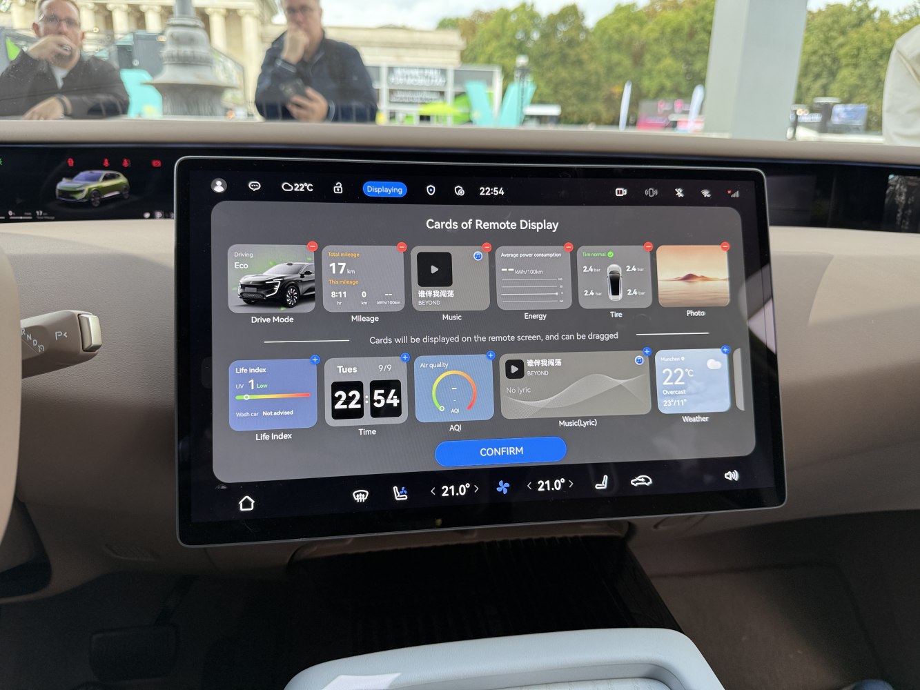 Digital dashboard showing drive mode, mileage, energy, tire pressure, music, and weather info.