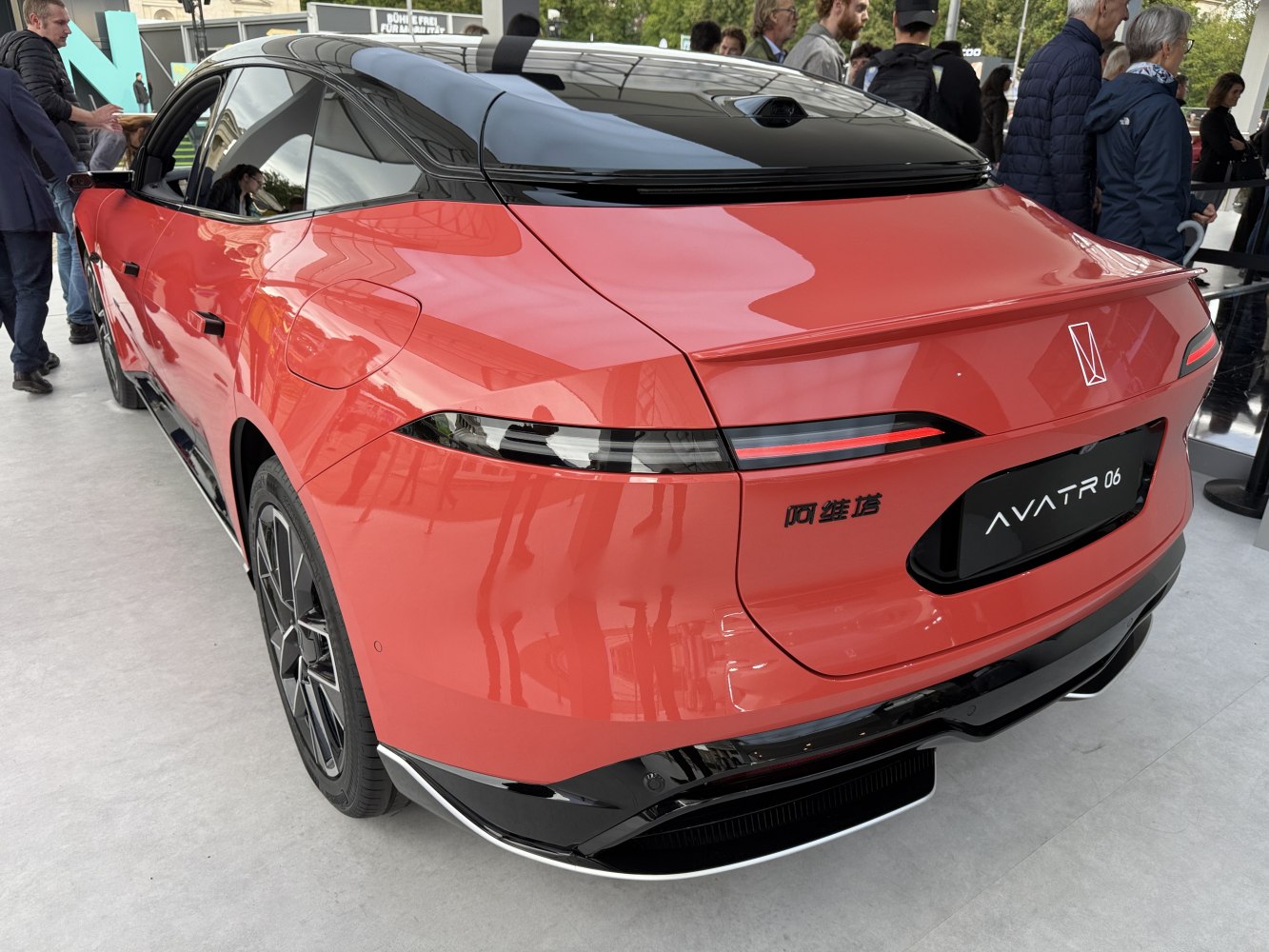 Sleek rear end with slim horizontal tail lights and black roof