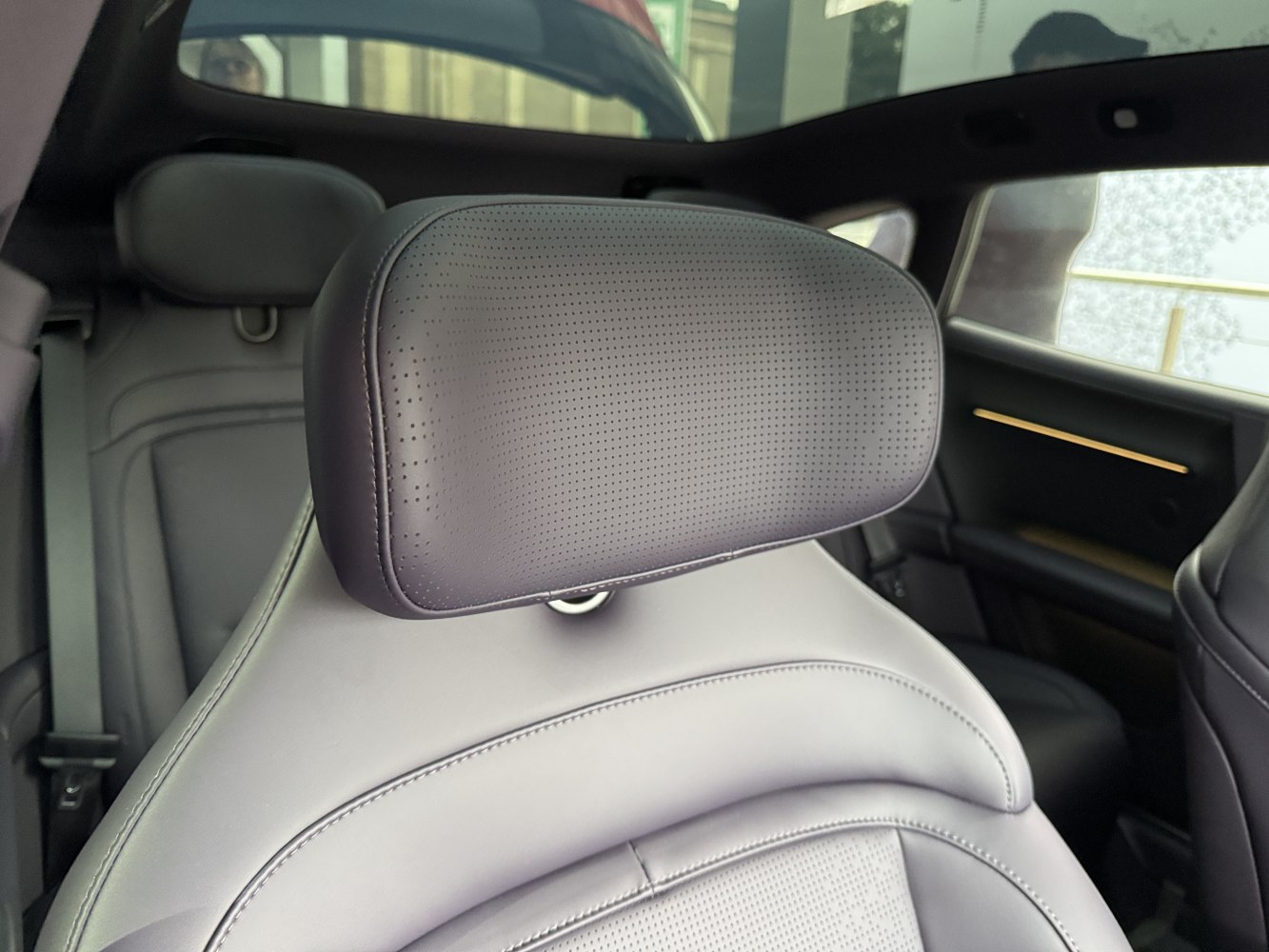Perforated leather car seat headrest and interior details