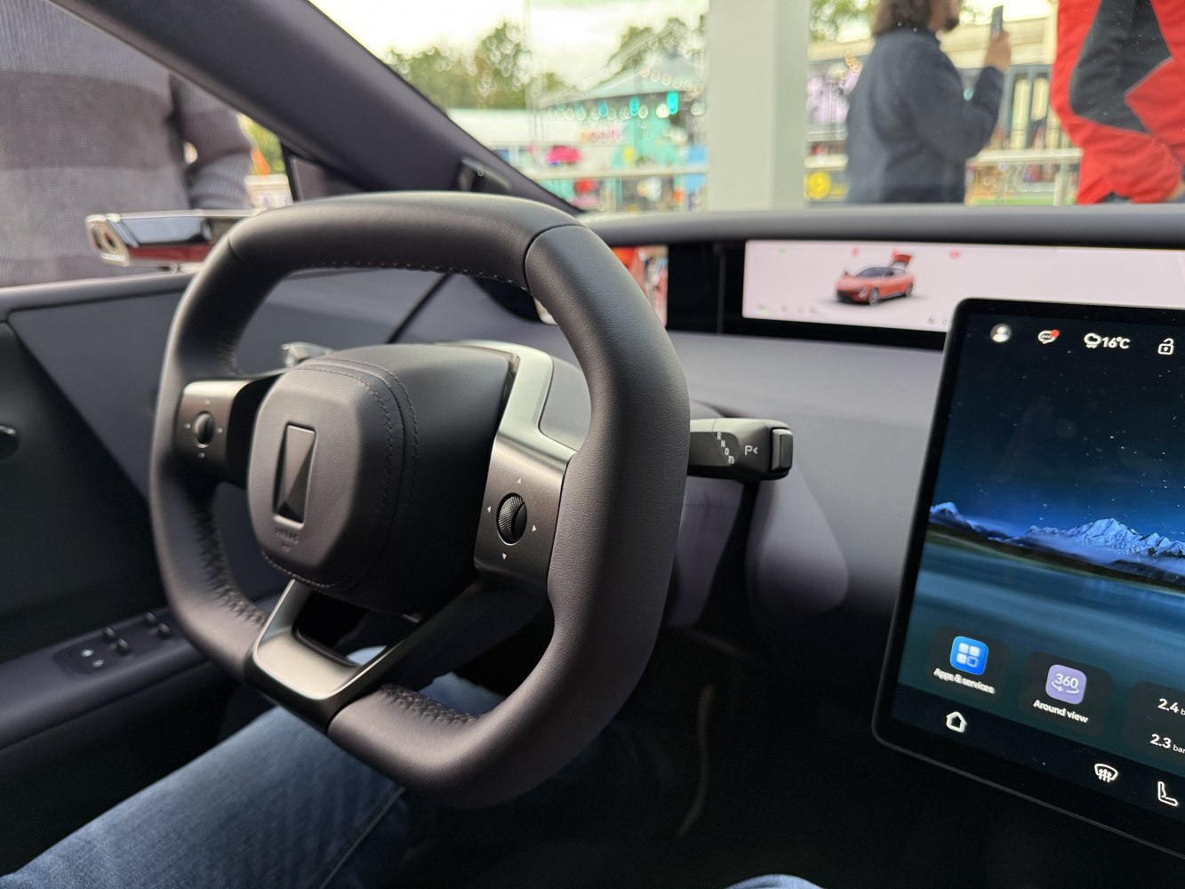 Minimalist steering wheel with integrated buttons and widescreen digital dashboard displays