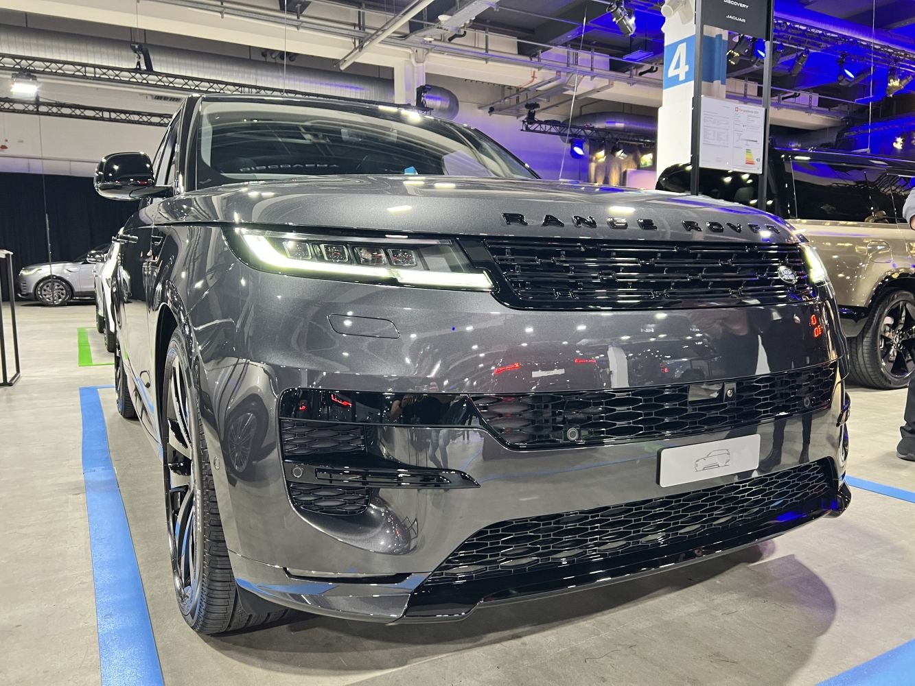 Sleek front grille and LED headlights of a modern luxury SUV.