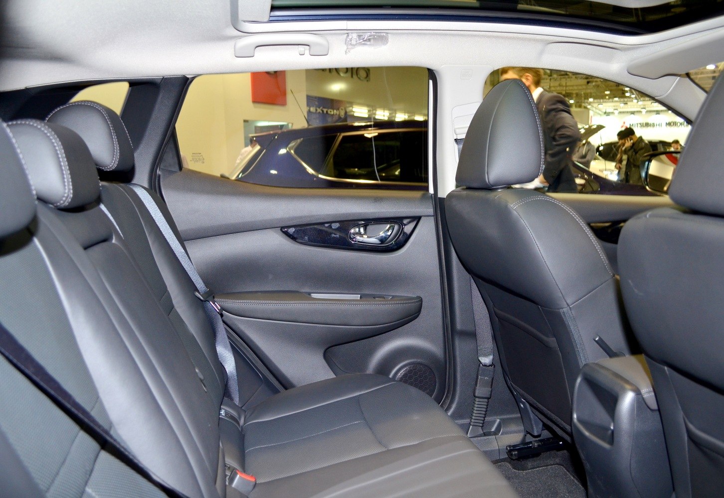 Rear interior seating and door panel with leather upholstery and chrome handle