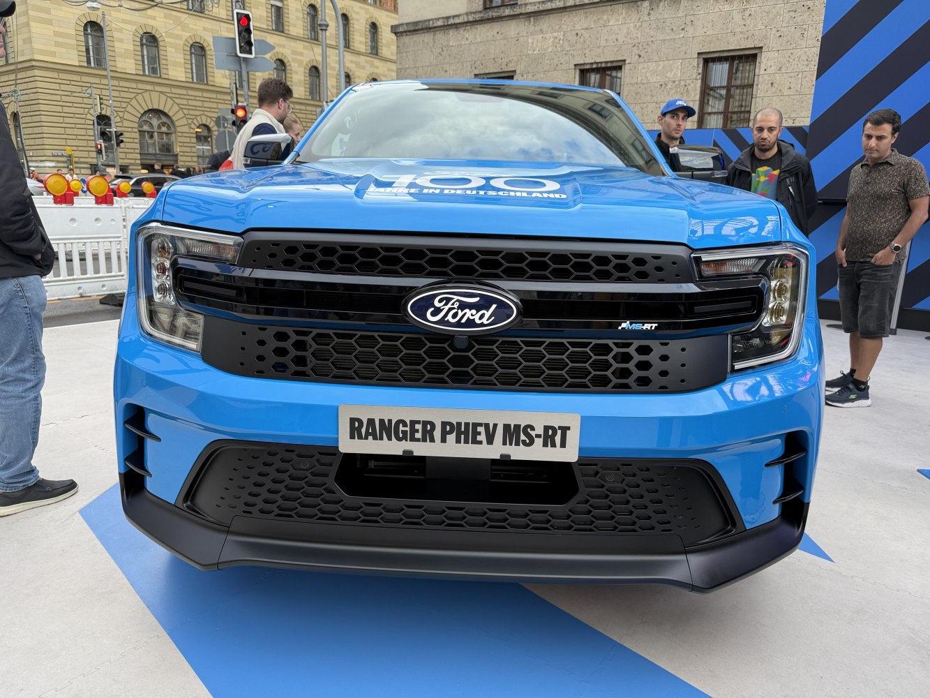 Blue pickup front with honeycomb grille and headlights