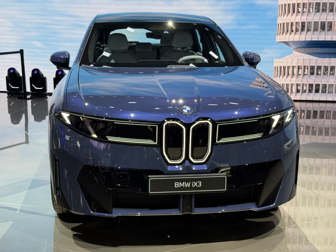 Front view with illuminated vertical grille and modern LED headlights