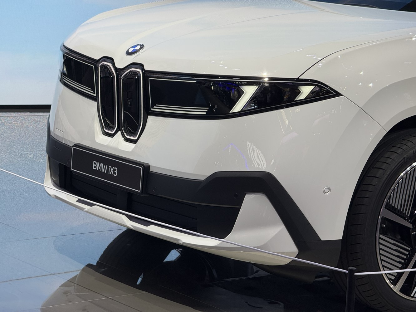 Front grille and distinct angular LED headlights of a modern electric SUV