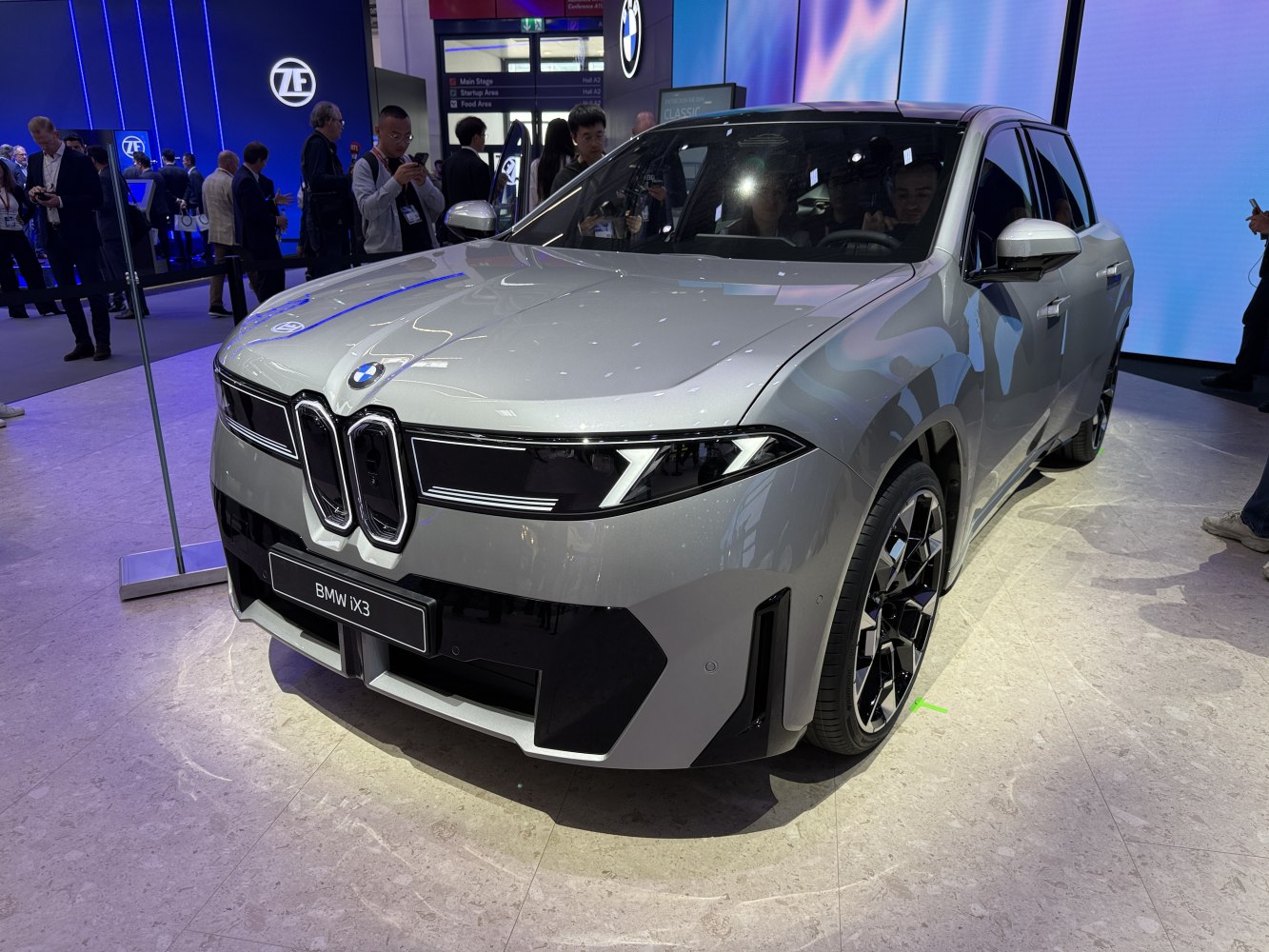 Front view with kidney grille design and LED headlights of an electric SUV.