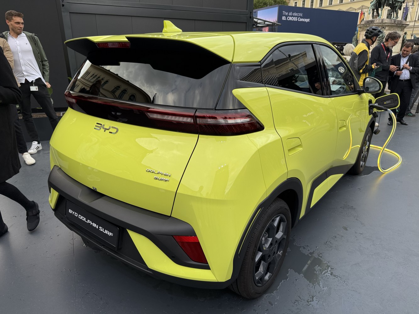 Rear view of electric hatchback charging with sleek tail lights