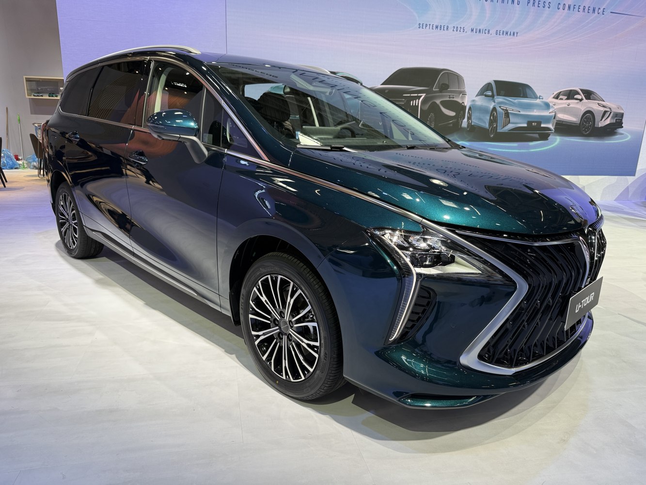 Front view of a modern MPV with sharp lines and LED headlights