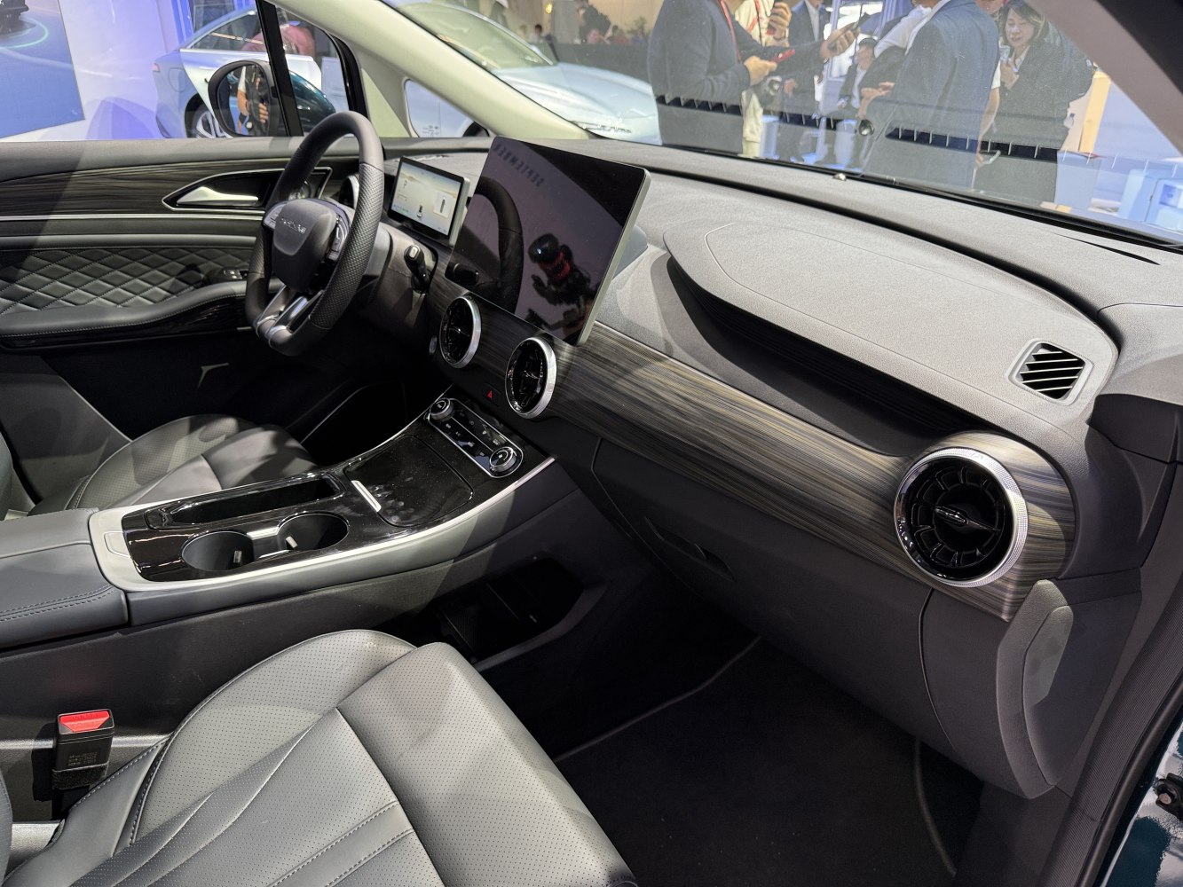 Detailed modern car dashboard with widescreen display and steering wheel