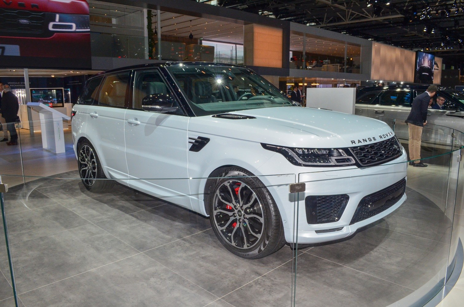 Front view of luxury SUV with LED headlights, black alloy wheels, and hood vents
