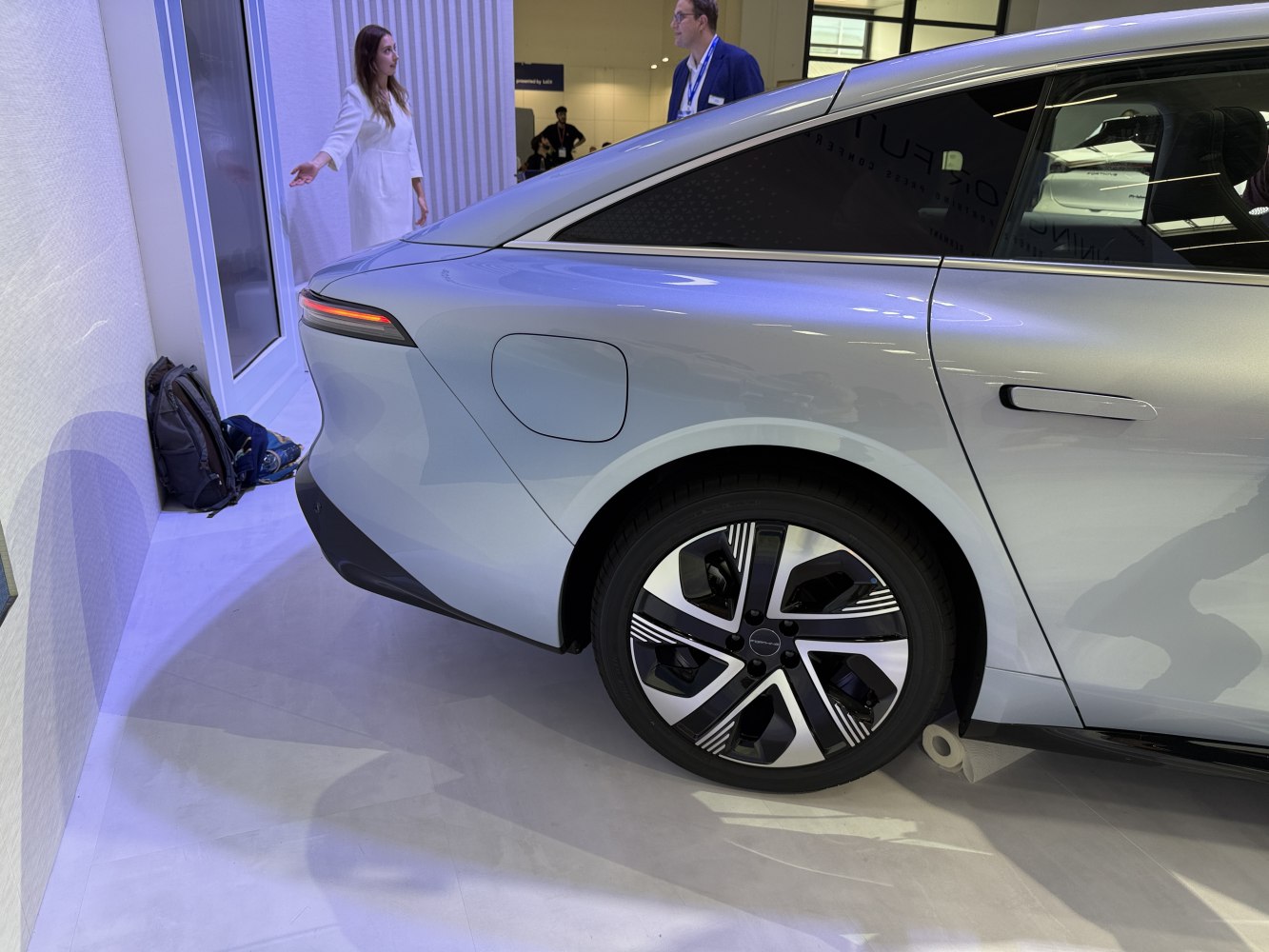 Rear side with aerodynamic taillight and futuristic alloy wheel design.