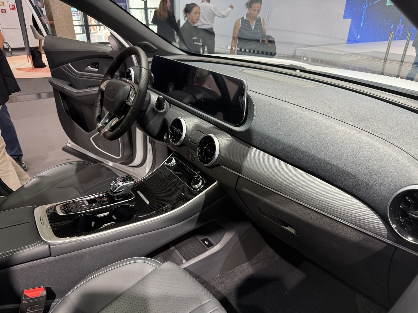 Wide digital dashboard, circular air vents, center console with gear shift