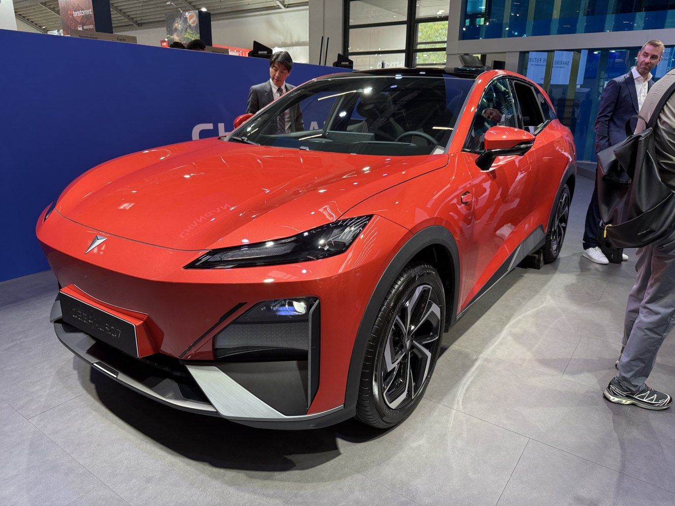 Sleek front view with sharp headlamps and sporty bumper in red