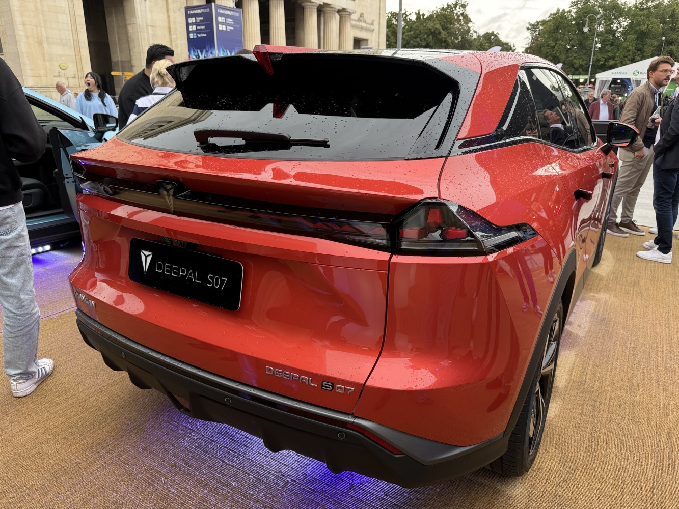 Rear view of a sporty hatchback with LED tail lights and a red exterior