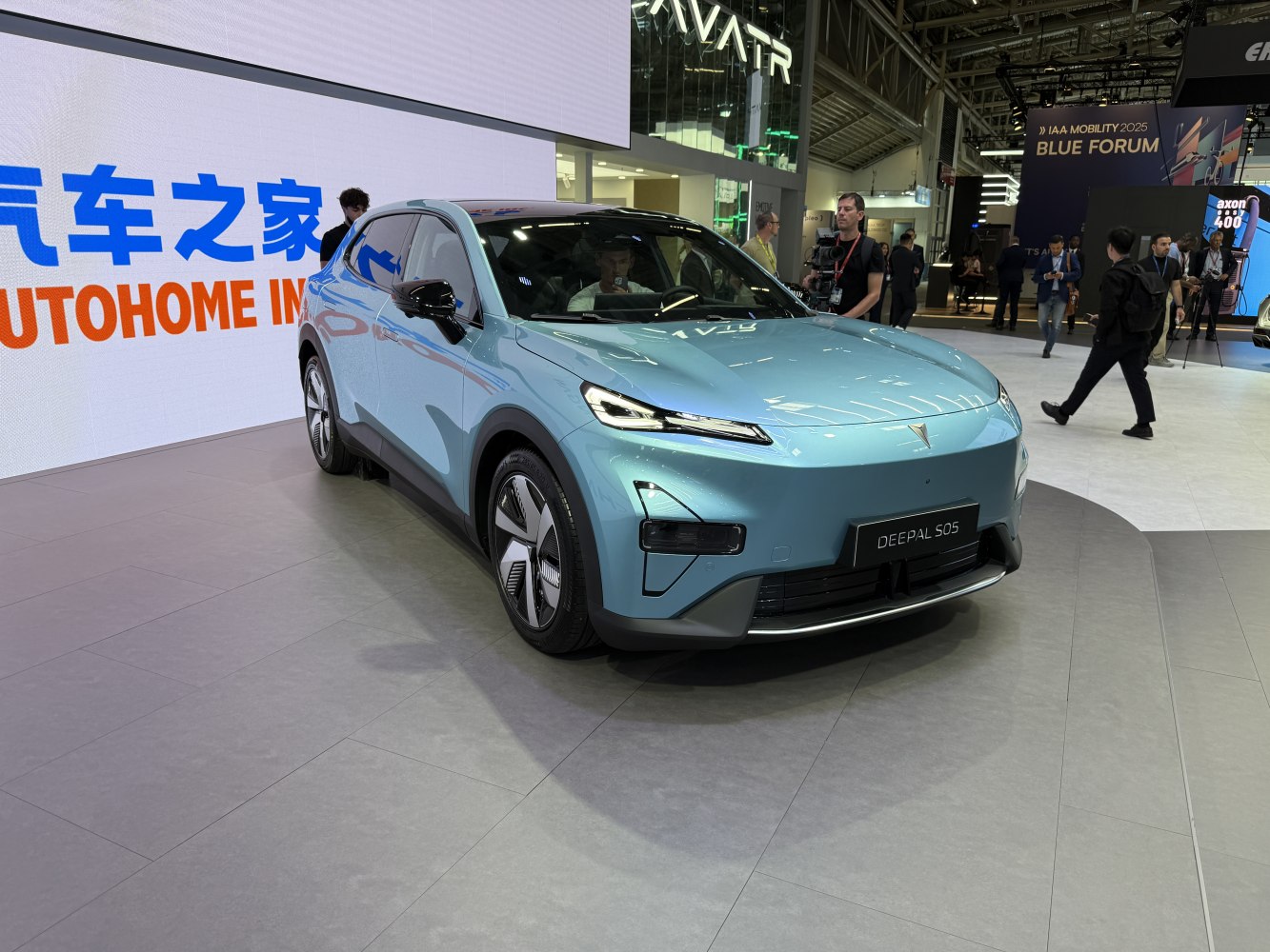 Aerodynamic electric SUV with LED headlights and unique wheels in angled front view