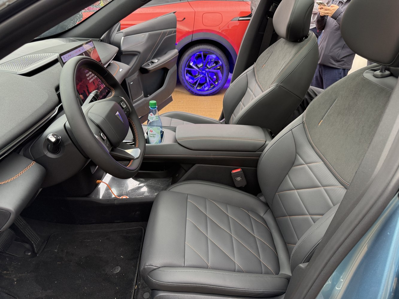 Modern steering wheel, digital dashboard, and premium leather seats