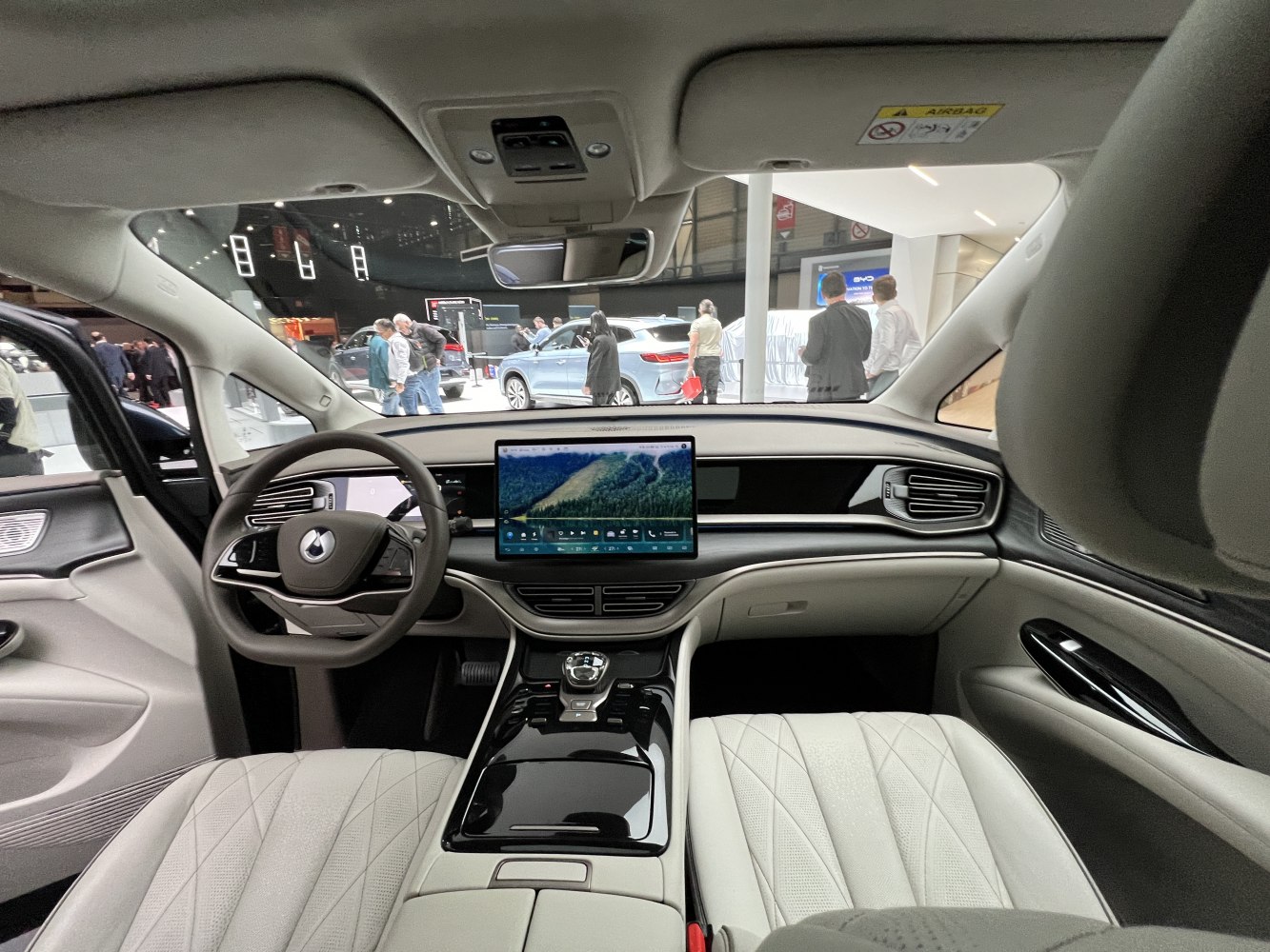 Modern car interior with digital dashboard and large touchscreen.