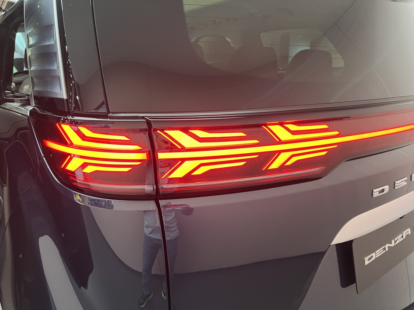Close-up of modern LED taillight with dynamic pattern.