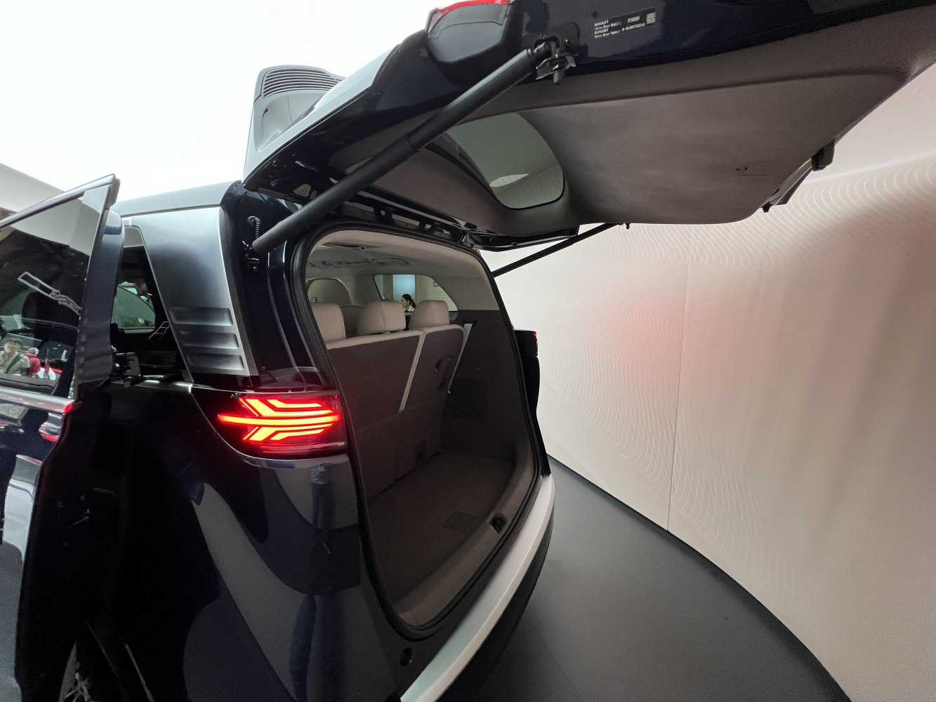 Open rear trunk and LED tail light of a modern SUV.