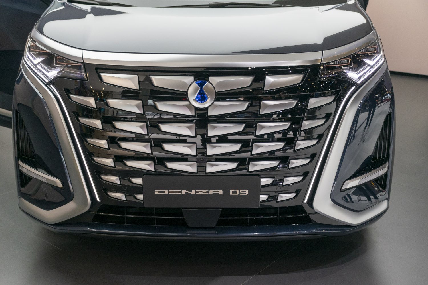 Close-up of front grille and LED headlights with badge