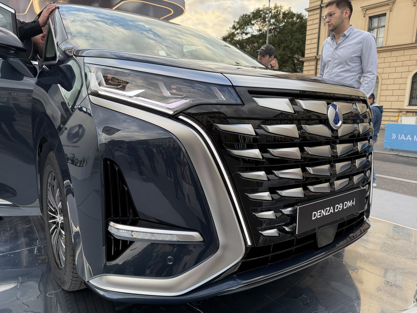 Close-up of Denza D9 front grille and headlight design with chrome detailing