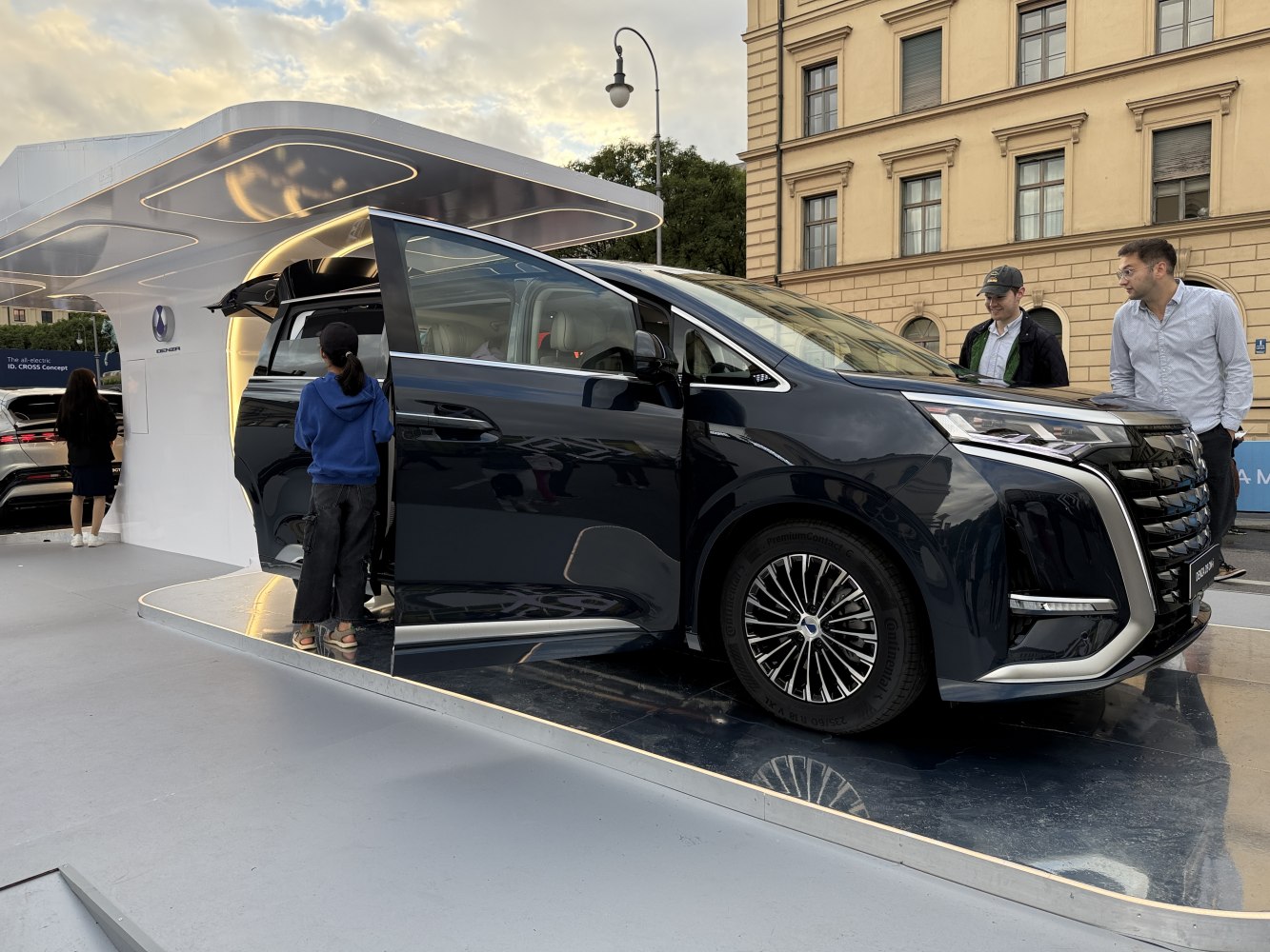 Black minivan with open sliding door and modern alloy wheels