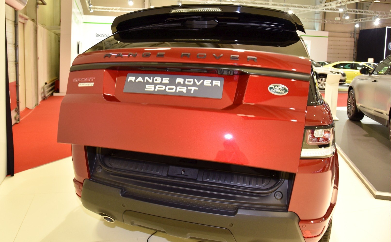 Open tailgate and rear taillights of red SUV