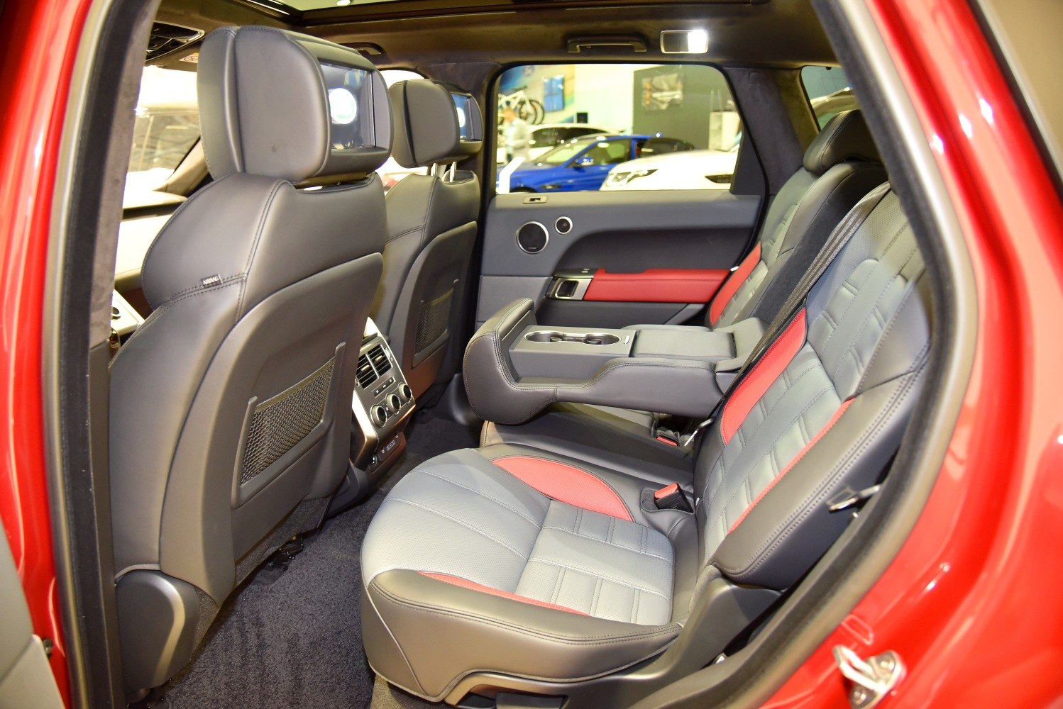 Luxury rear passenger seats with leather upholstery and headrest screens