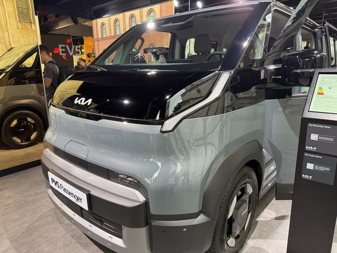 Front view of van with modern LED headlights and sleek black-gray design