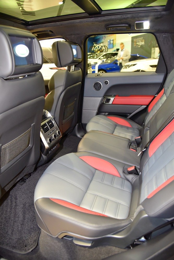 Rear seat interior with dual entertainment screens and two-tone leather upholstery