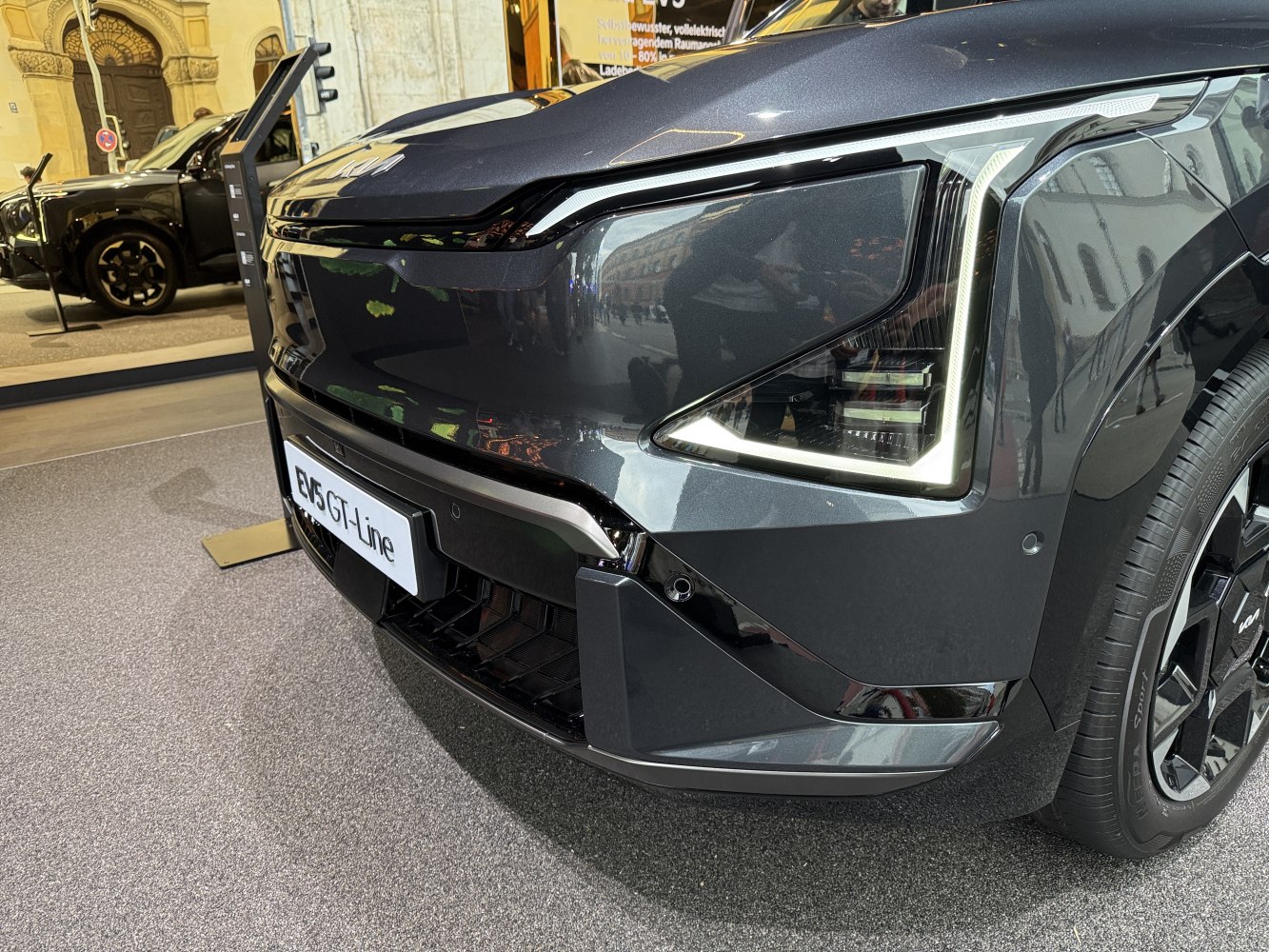 Close-up of the front end and LED headlight design with grille of a modern electric vehicle.