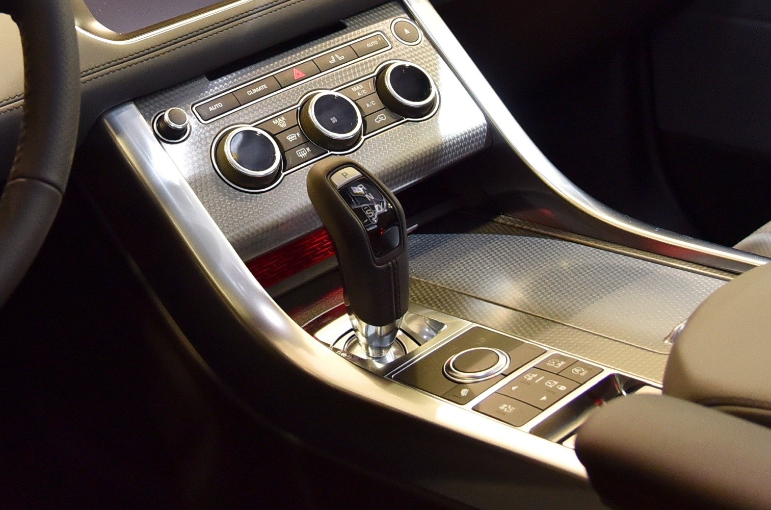 Gear shift lever and climate control panel in luxury SUV center console