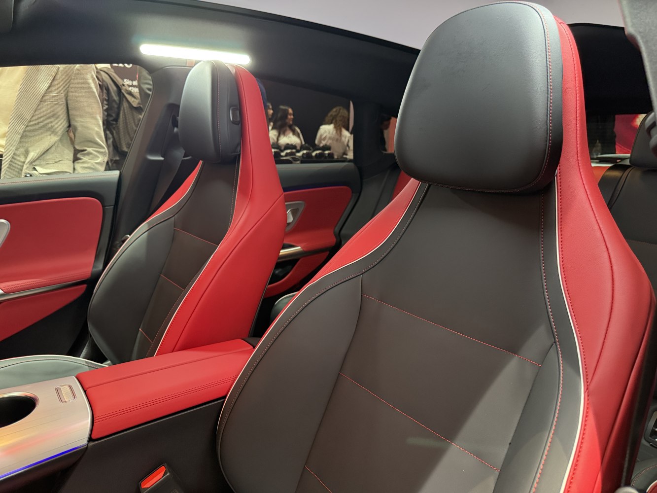 Two-tone red and black leather sport front seats with detailed stitching.