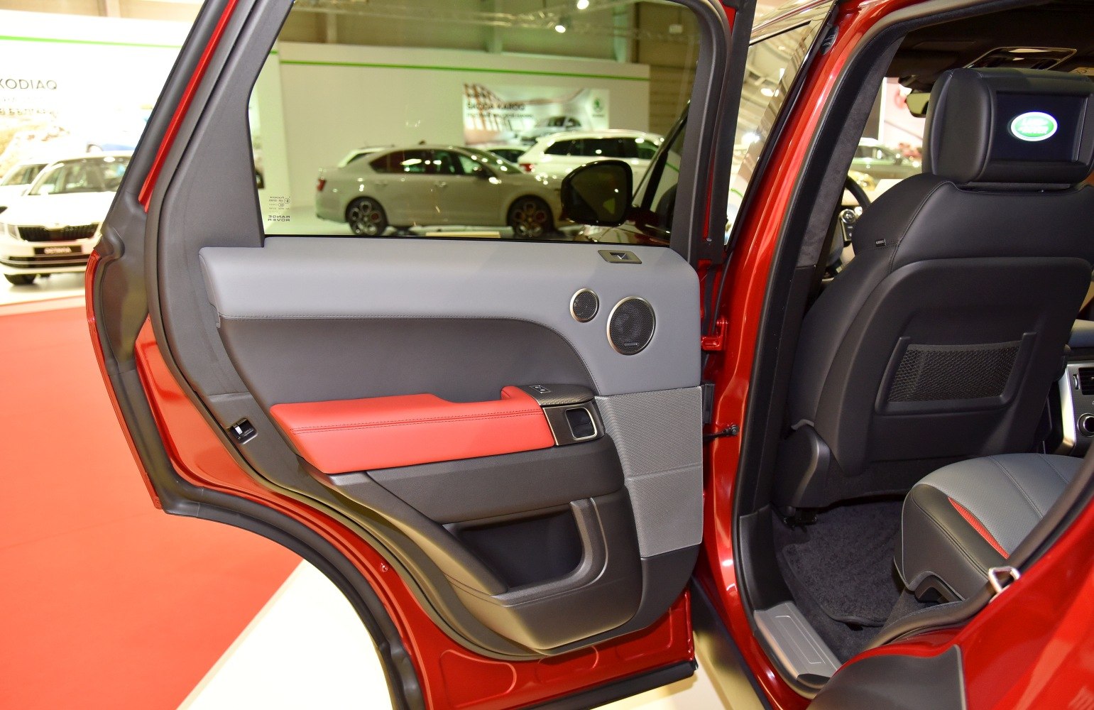 Rear door interior with speakers and red leather trim