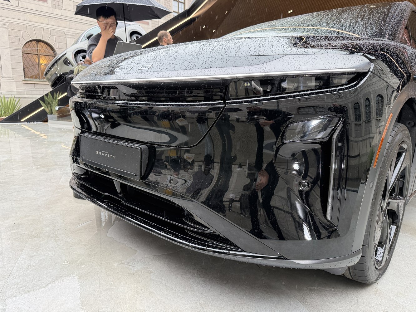 Close-up of electric SUV front with LED lights and aerodynamic design.