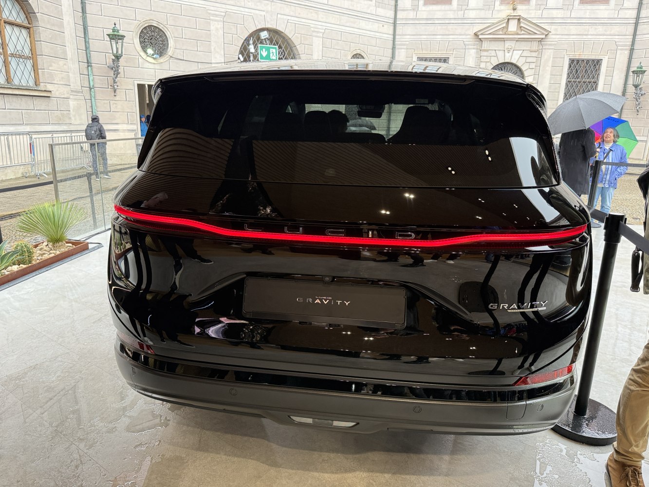 Full-width red LED tail light and glossy black SUV rear design