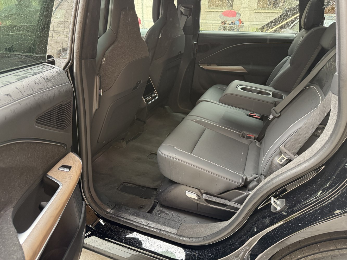 Spacious and luxurious rear seat interior with premium materials and cup holders