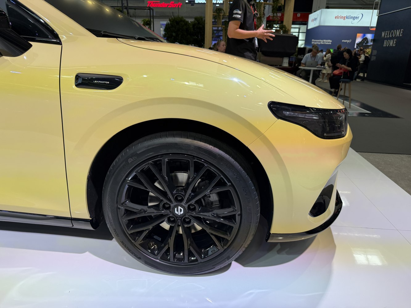 Front wheel with black alloy rim and sleek headlight details